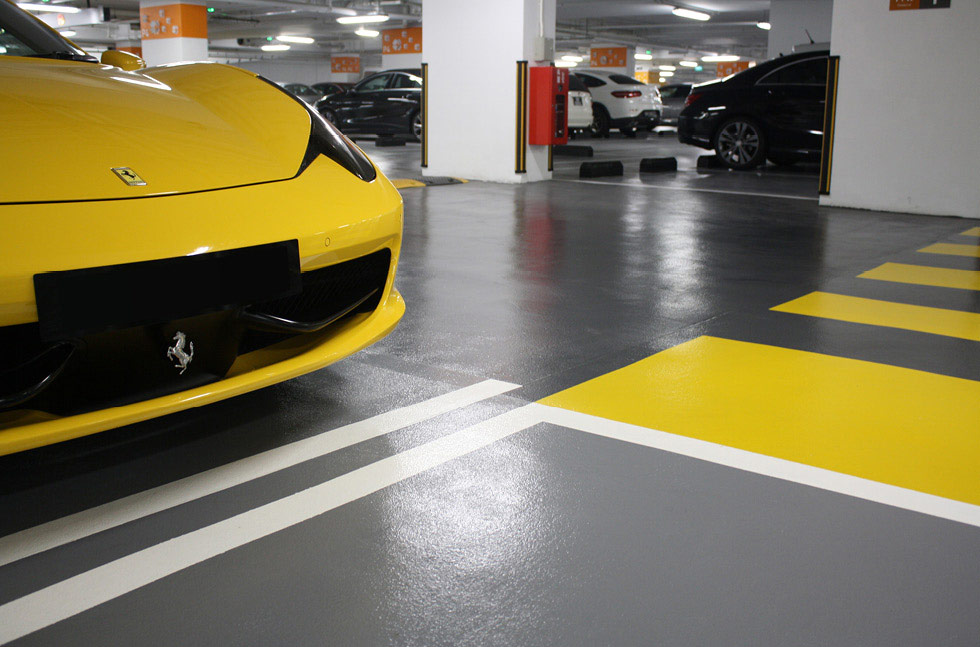 Premium car park deck with grey and yellow PU floor coating and parked vehicles